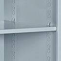 Storage cabinet features two fixed shelves and one adjustable shelf.