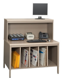 This parcel station has an adjustable height CTA style table that provides convenient storage for courier packaging with vertical dividers, as well as a riser with laminate top that provides a place for monitors and equipment. 
